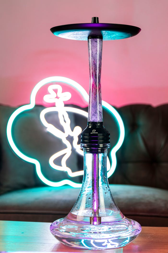 Modern hookah with vibrant neon backdrop, creating a vivid indoor setting.